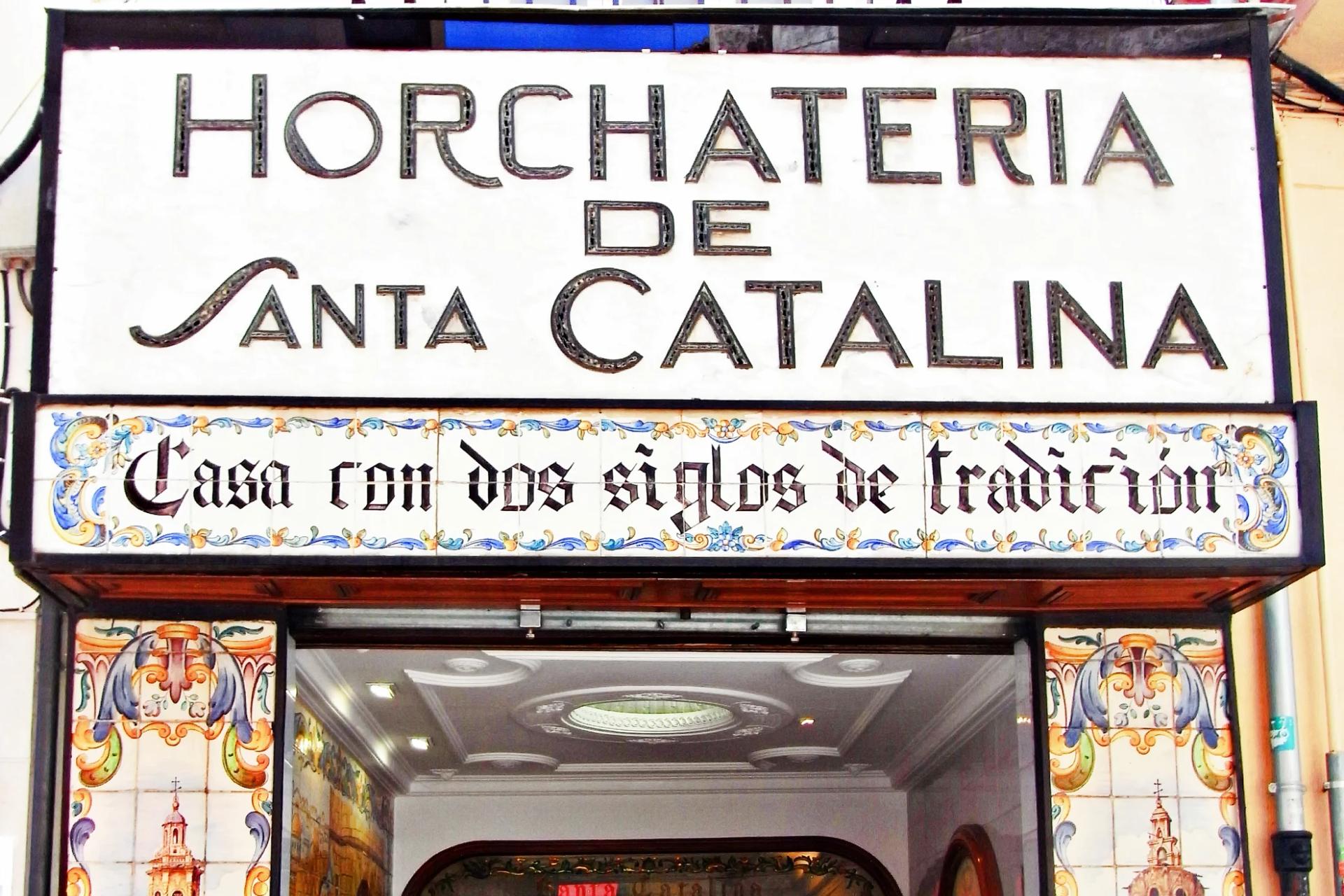 Entrada de la Horchatería de Santa Catalina, con su rótulo y paneles de azulejos a los lados